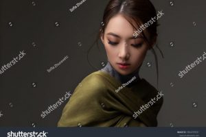 stock-photo-beautiful-asian-woman-in-a-green-shawl-beauty-of-mysterious-chinese-girl-with-flowing-hair-1864707031