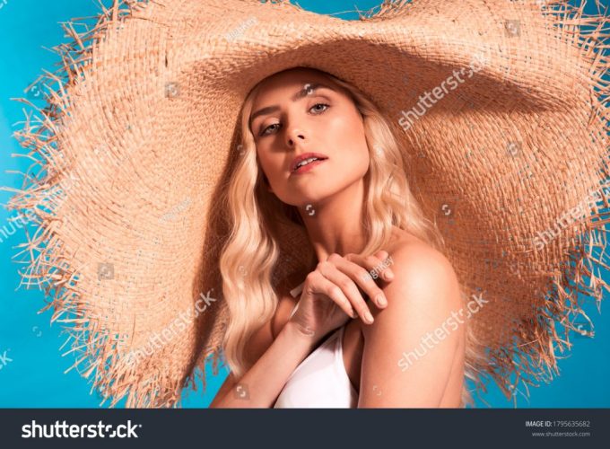 stock-photo-beautiful-fashionable-young-blonde-woman-in-a-studio-wearing-white-swimsuit-big-straw-summer-hat-1795635682