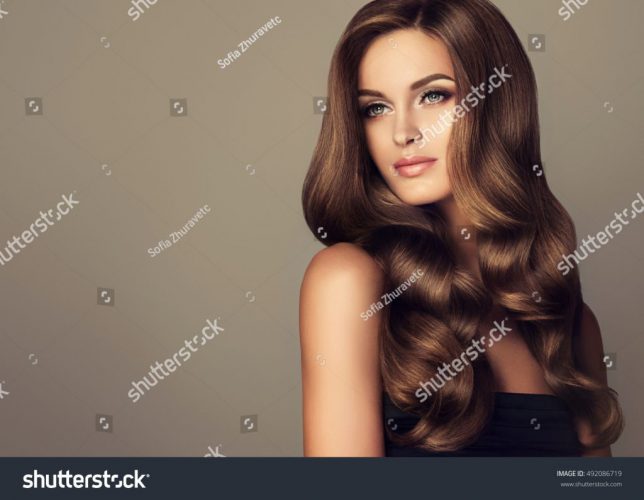 stock-photo-beautiful-girl-with-long-wavy-and-shiny-hair-brunette-woman-with-curly-hairstyle-492086719