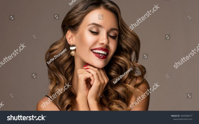 stock-photo-beautiful-smiling-woman-with-long-wavy-hair-girl-curly-hairstyle-and-red-manicure-nails-1859398477