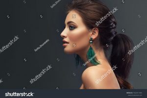 stock-photo-beautiful-woman-with-long-big-earrings-beauty-girl-with-elegant-hairstyle-and-evening-make-up-1922411405