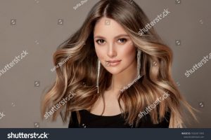 stock-photo-beauty-girl-with-long-and-shiny-wavy-hair-coloring-and-toning-shatush-and-balayash-1922411393