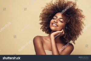 stock-photo-beauty-portrait-of-african-american-woman-with-clean-healthy-skin-on-beige-background-smiling-1896749464