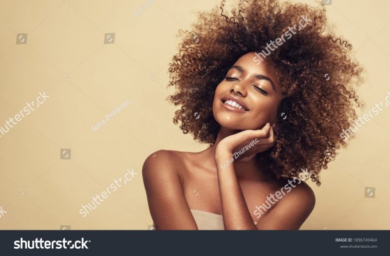 stock-photo-beauty-portrait-of-african-american-woman-with-clean-healthy-skin-on-beige-background-smiling-1896749464