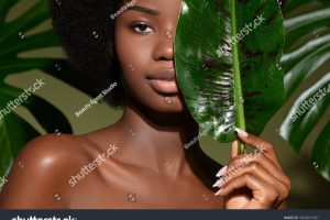 stock-photo-beauty-portrait-of-young-beautiful-african-american-woman-with-posing-with-banana-leaf-curly-hair-1869815587