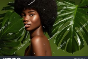stock-photo-beauty-portrait-young-african-american-woman-posing-agaings-tropical-green-leaf-natural-cosmetics-2139288753
