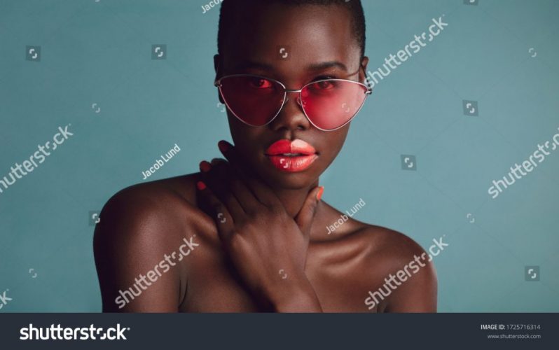 stock-photo-close-up-of-a-stunning-woman-with-vibrant-makeup-wearing-sunglasses-african-female-model-looking-1725716314