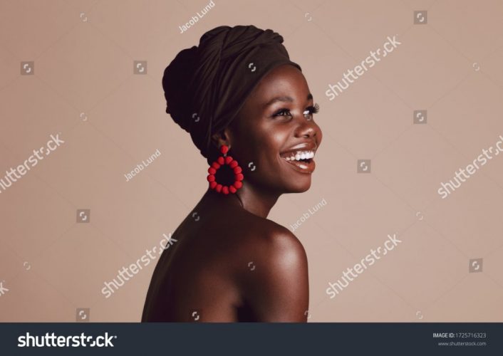 stock-photo-close-up-of-smiling-african-woman-on-beige-background-beautiful-female-model-with-a-cloth-wrapped-1725716323