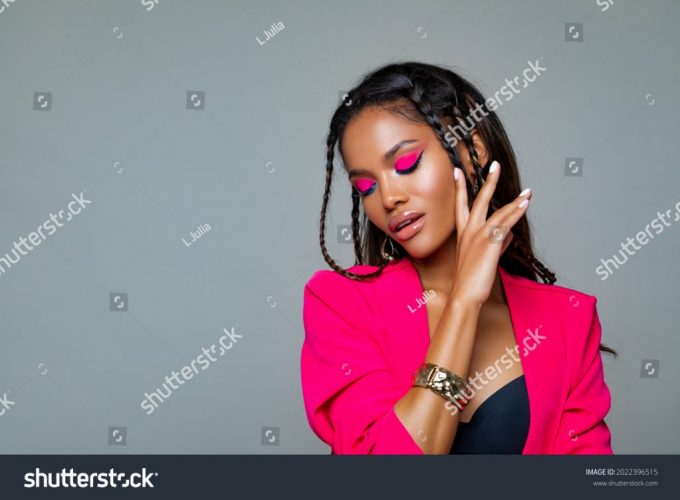 stock-photo-fashion-portrait-black-woman-in-pink-stylish-jacket-pink-makeup-curly-hair-and-braids-luxury-2022396515