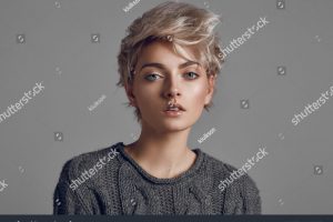 stock-photo-fashion-portrait-of-young-woman-with-blond-short-hair-isoalted-on-gray-background-1219467637
