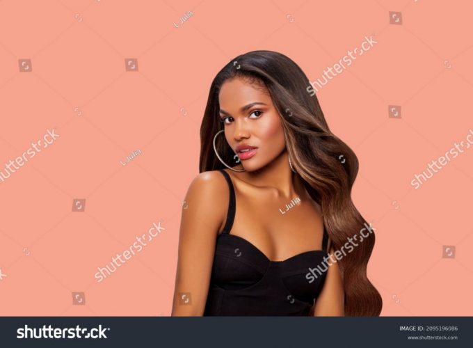 stock-photo-hair-beauty-portrait-of-a-black-woman-with-long-curly-brown-hair-makeup-african-american-model-2095196086