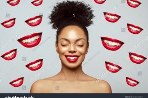 stock-photo-overjoying-young-beautiful-african-american-model-with-closed-eyes-smiling-against-many-smiley-2161110933