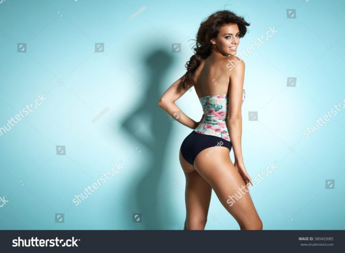 stock-photo-portrait-of-a-cheerful-tanned-lady-380403085