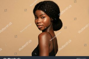 stock-photo-portrait-of-beautiful-african-american-woman-with-curly-hair-against-beige-background-2013470879