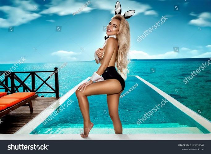 stock-photo-sexy-blonde-model-dressed-in-easter-bunny-costume-and-bunny-ears-is-standing-in-pool-on-maldives-2143533369