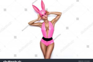 stock-photo-sexy-blonde-woman-posing-in-latex-pink-costume-and-pink-bunny-mask-on-white-background-easter-2134518823