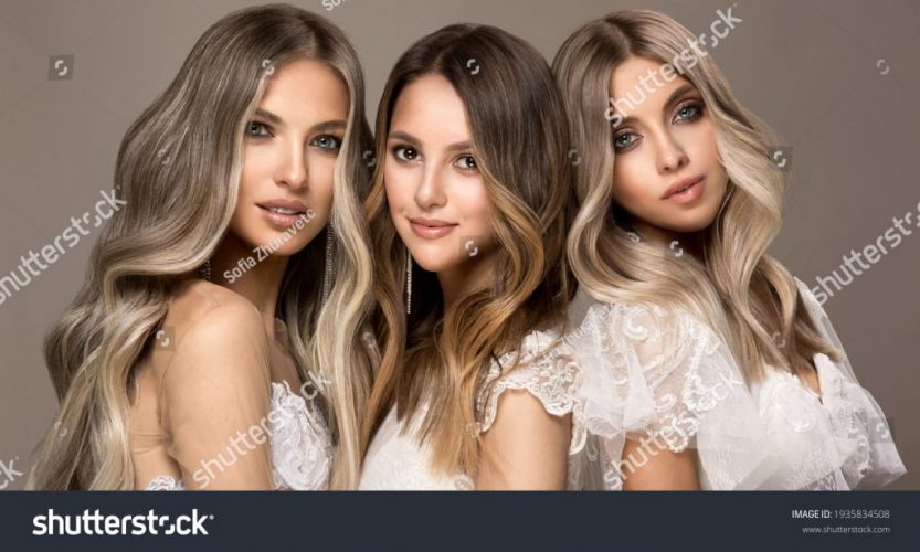 stock-photo-three-beautiful-girls-in-white-wedding-dresses-with-hair-coloring-in-ultra-blond-stylish-1935834508